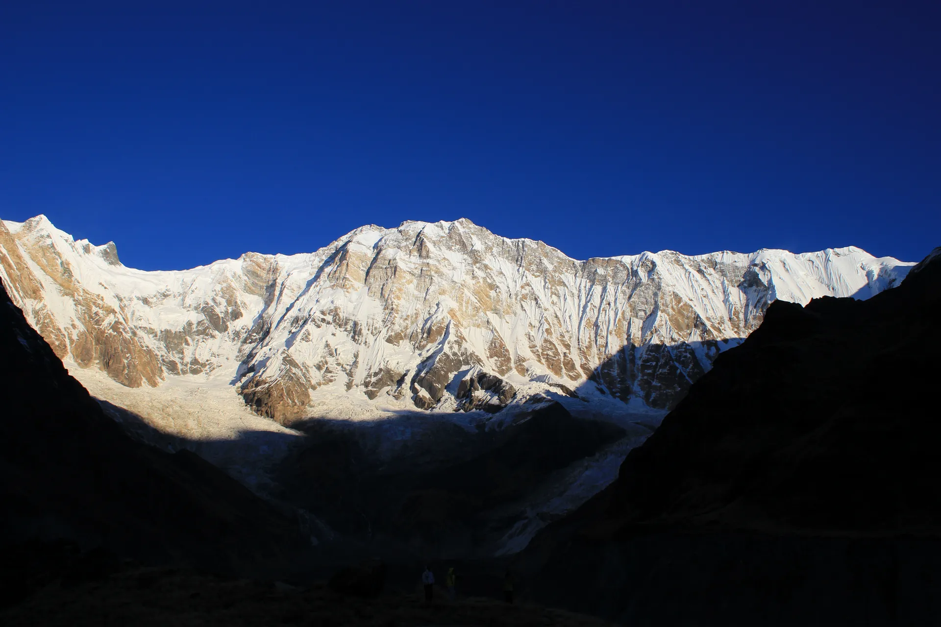 Early morning light hitting the Annapurna south face with glacier valley in shadow