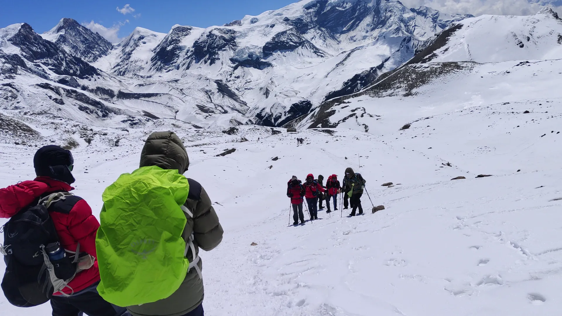 Trekking group ascending a snowy slope on the Thorong La approach