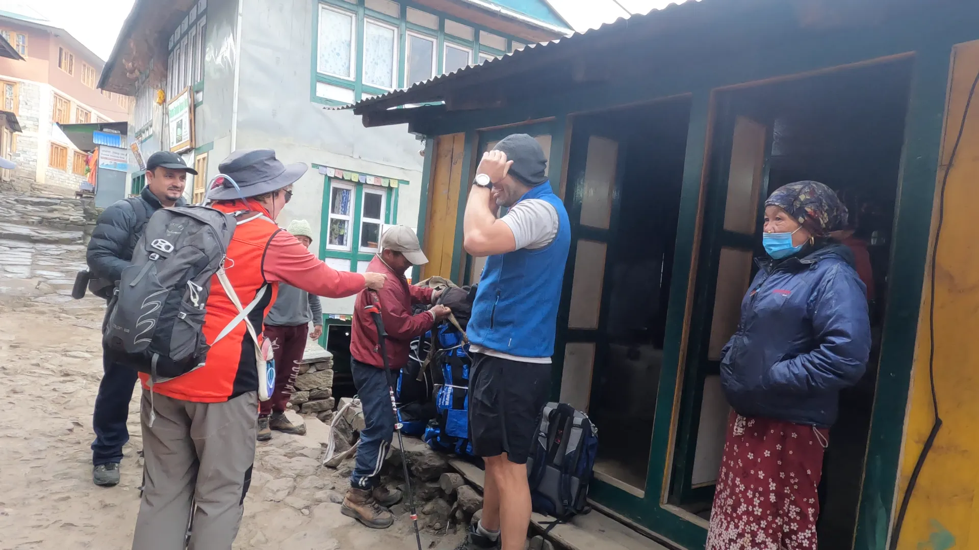 Trekking group and locals gathering at a village stop on the trail