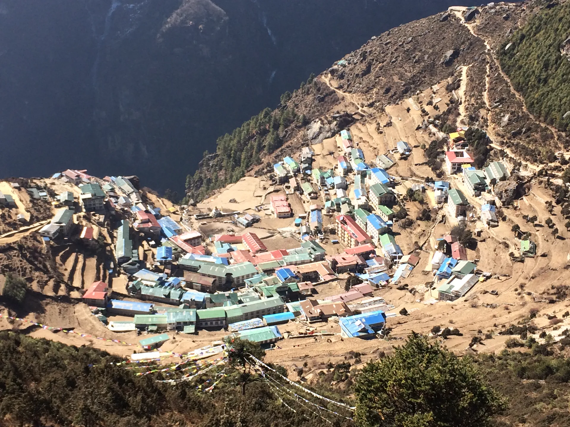 Aerial view of Namche Bazaar with colorful rooftops terraced into a hillside