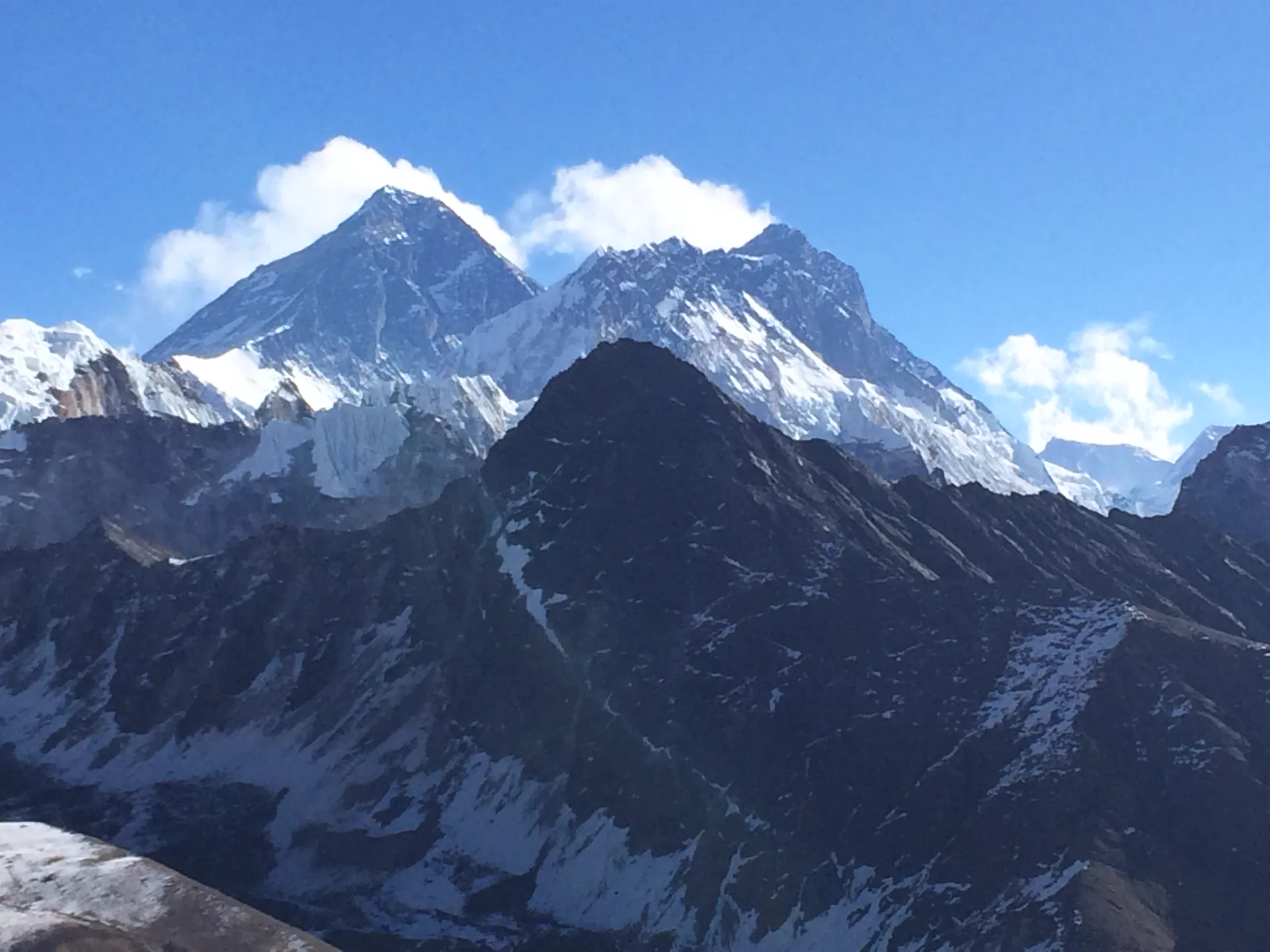 Wide view of Everest and Lhotse with dark foreground ridge from Gokyo Ri