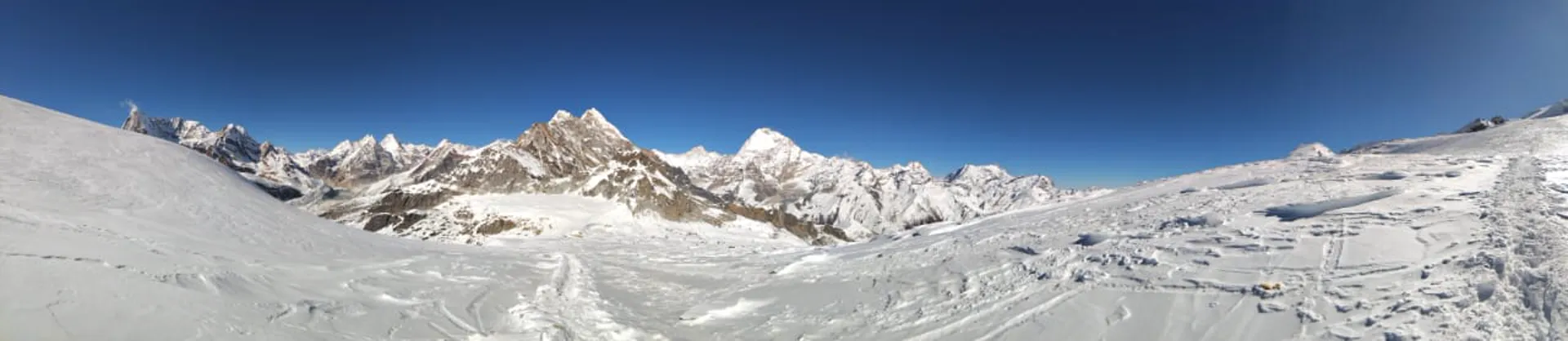 Panoramic view of snow-covered Himalayan peaks and glacier from high altitude
