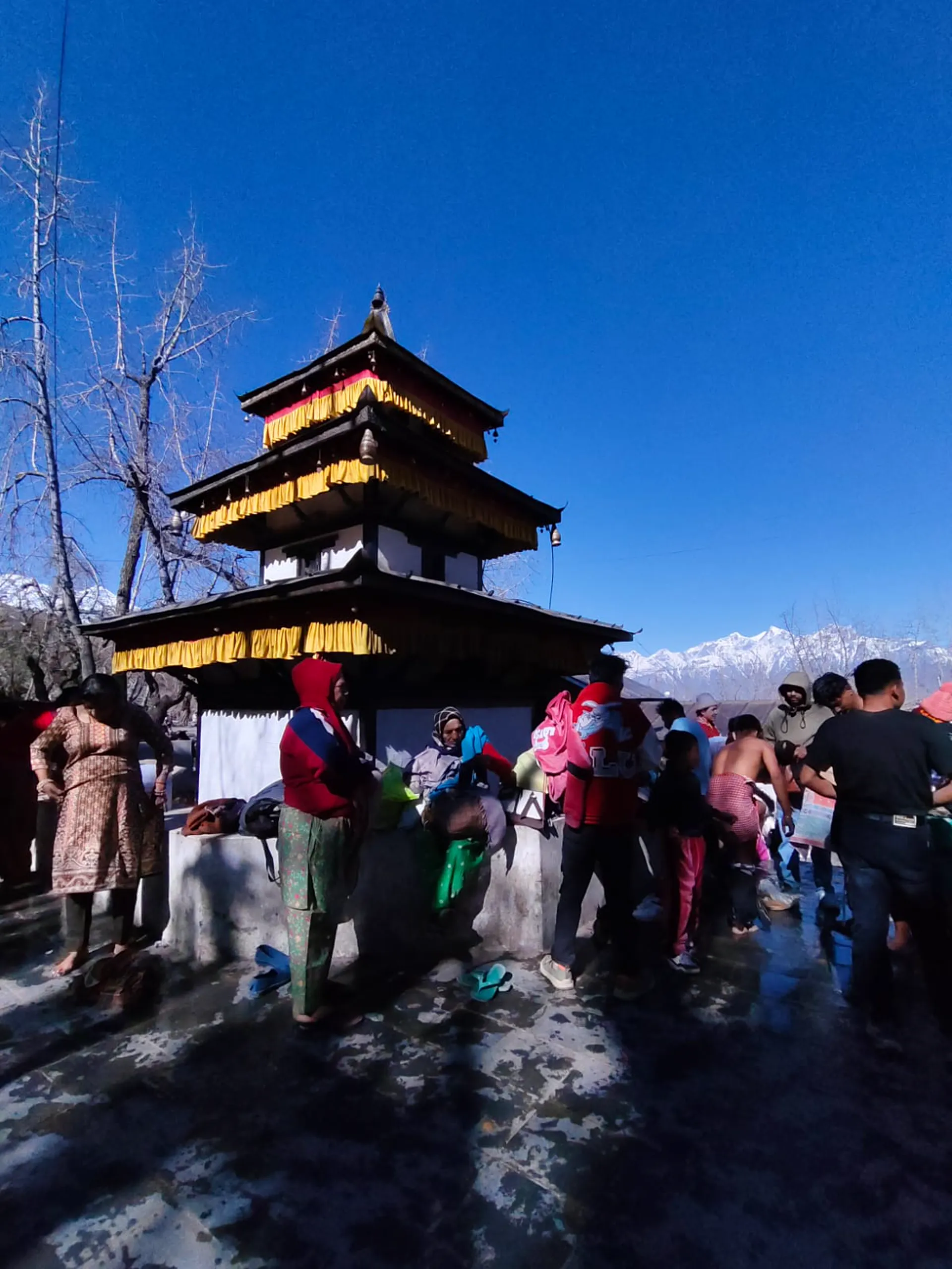 Muktinath Temple pagoda draped in golden cloth with pilgrims at 3,800m in Mustang district Nepal