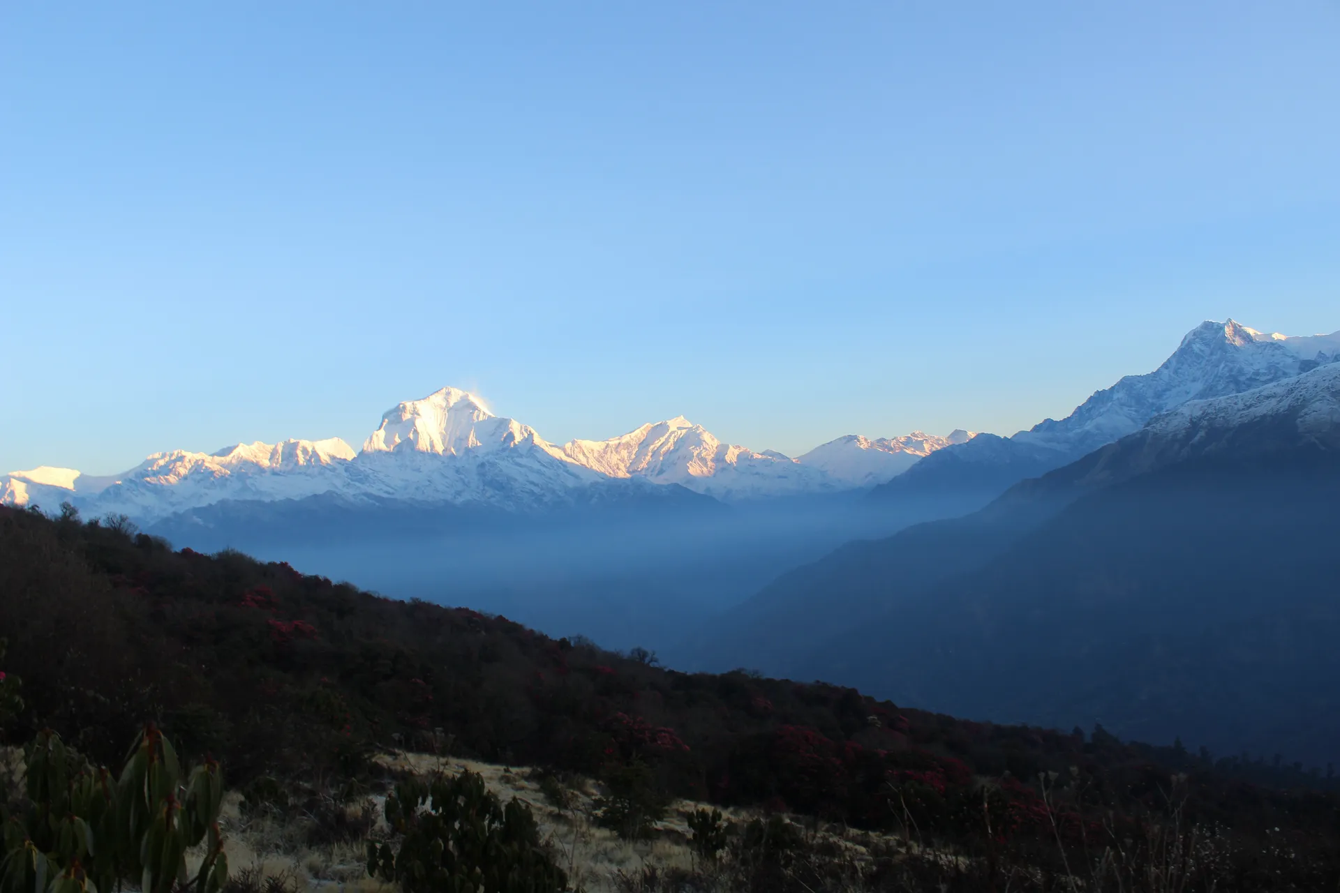 Dawn view of Annapurna and Dhaulagiri ranges with morning haze in the valley