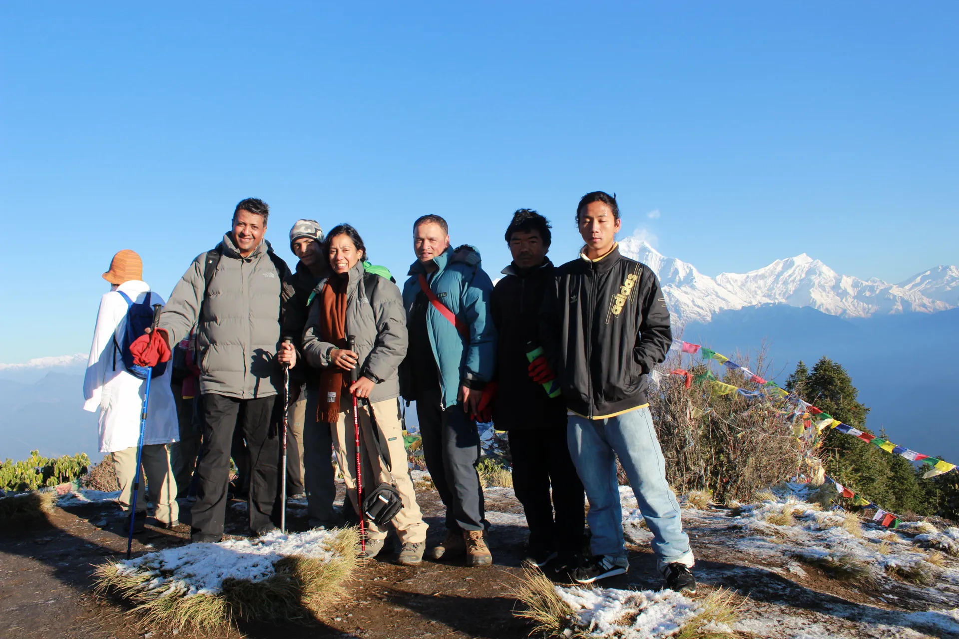 Crowd of trekkers at Poon Hill summit with clear Dhaulagiri range view