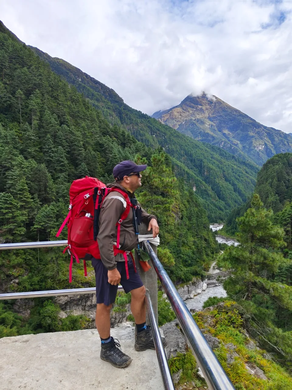 Prem overlooking a valley from a suspension bridge in Khumbu
