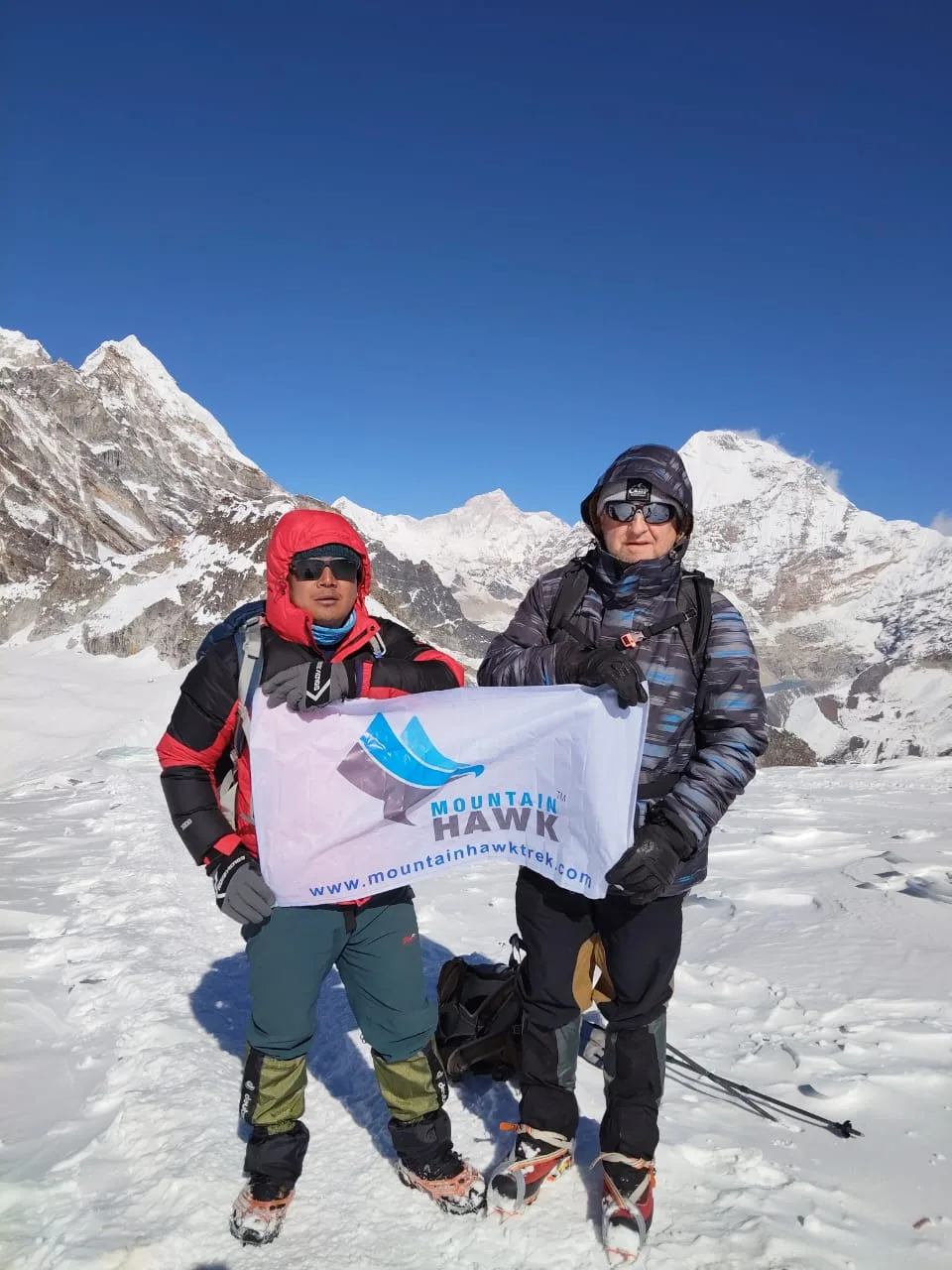 Guide and climber with Mountain Hawk Trek flag